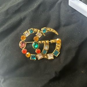 GG pin with multicolored embellishments